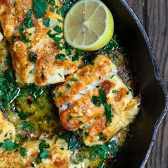 a skillet filled with chicken covered in sauce and garnished with parsley