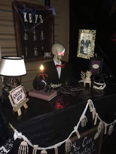 a table topped with halloween decorations and skeletons