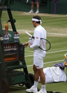 a man holding a tennis racquet on top of a tennis court