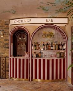 a bar with red and white stripes on the front, behind it is a brick wall