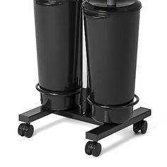 two black trash cans sitting on top of a dolly