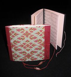 an open book with a string attached to it