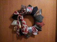 a close up of a wreath made out of different types of ties on a door