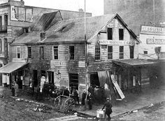 an old black and white photo of people in front of a building