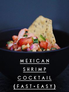 mexican shrimp cocktail recipe in a black bowl with tortilla chips on the side