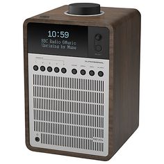 an old fashioned radio sitting on top of a wooden stand