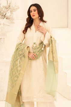 Illuminate your wardrobe with our expertly crafted White and Green Shalwar Kameez. Made with luxurious khaadi silk, intricately embroidered with motifs and embellished with dabka and beads for a touch of elegance. Complete your look with our jamawar organza mint green dupatta for a perfect finish. Perfect for formal events and special occasions. Festive Cream Chanderi Salwar Kameez, Traditional Silk Wear With Dupatta And Straight Kurta, Transitional Dola Silk Churidar With Dabka Work, Semi-stitched Raw Silk Kurta With Dabka Work, Designer Traditional Churidar In Pista Green, Cream Chanderi Sharara For Eid, Designer Pista Green Chanderi Churidar, Pista Green Chanderi Churidar For Designer Wear, Transitional Raw Silk Kurta With Dupatta