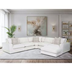 a large white sectional couch in a living room with a painting on the wall behind it