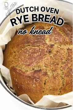 a round loaf of rye bread in a pan with the words dutch oven rye bread no knead