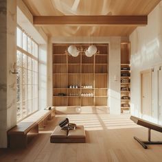 an empty room with wooden floors and shelves on the wall, along with two large windows