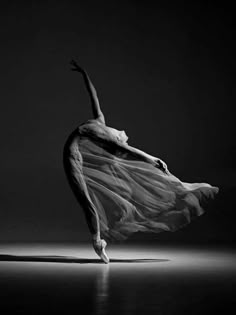 a black and white photo of a ballerina