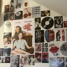 a wall covered with various movie posters and vinyl record records in different colors, sizes and shapes