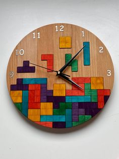 a clock made out of wooden blocks with numbers on it