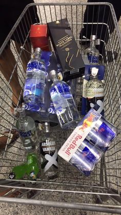 a shopping cart filled with bottled water and liquor