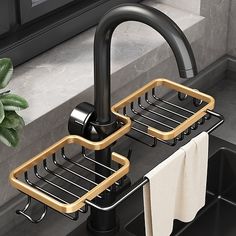 two black and gold sink faucets with towels hanging from them