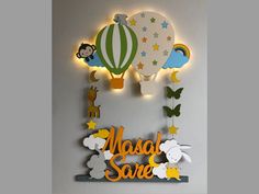 a sign that says masala save with hot air balloons and animals on the wall