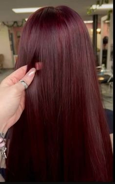 This deep red shade blends purple, copper, and chocolate brown to create a vibrant hair color that embodies the same warmth and richness of the drink that inspires its name. Red On Brunette Hair, Light Cherry Hair, Darkest Red Hair, Red Hair Pale Skin, Pelo Color Borgoña, Pelo Color Vino, Deep Auburn, Cherry Cola Hair