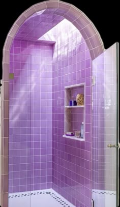 a bathroom with purple tiles on the shower wall and shelves in the corner, along with a white tiled floor