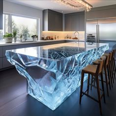 a kitchen with an island made out of ice and surrounded by stools in front of the counter