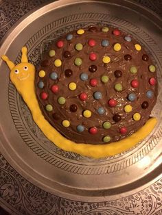 a chocolate cake decorated like a banana with m & m candies on it