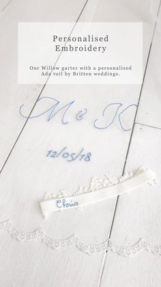 a white wooden floor with the words personalised embroidery on it and two blue letters