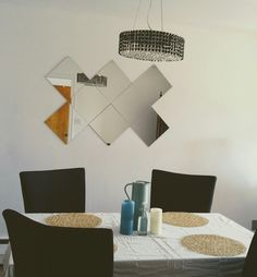 a white table with black chairs and a chandelier