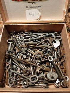 an open box filled with lots of old keys