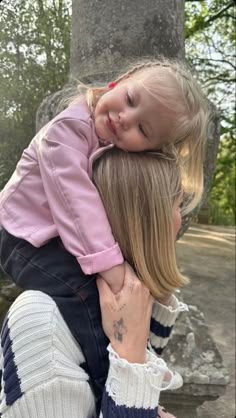 a woman holding a small child in her arms