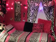 a bedroom decorated with zebra print and pink lights