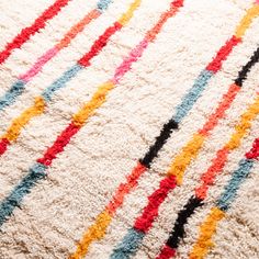 an area rug with multi colored lines on it