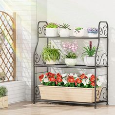 three tiered metal plant stand with flowers and plants in pots on the top shelf