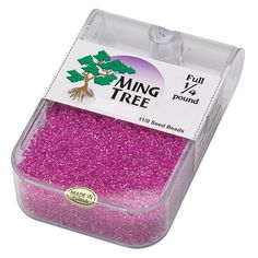 pink seed beads in a plastic container with the label on it's front side