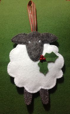 a sheep ornament hanging on a green wall