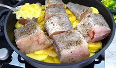 two pieces of fish are cooking in a skillet on the stove top with yellow flowers