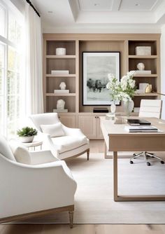 a living room filled with white furniture and bookshelves next to a large window