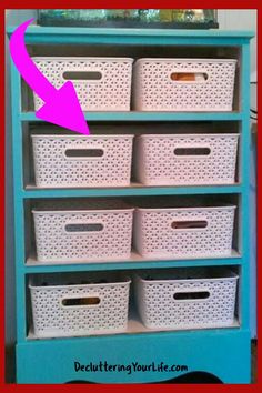 a blue bookcase with white baskets on top and an arrow pointing to the bottom