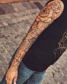 a man with a flower tattoo on his arm