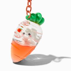 a glass necklace with an ice cream sundae in the shape of a bear on it's head