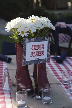 there is a boot with flowers in it on the table