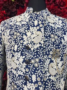 Step into sophistication with the Hardik Sherwani, a perfect blend of tradition and modern style. This navy blue sherwani, adorned with intricate white floral embroidery, exudes luxury and refinement, ideal for grooms or special occasions. Key Features: Elegant Design: Navy blue base with detailed white floral embroidery. High Collar: Adds a touch of classic elegance. Premium Quality Fabric: Ensures comfort and a perfect fit. Ideal for Weddings & Celebrations: Perfect for making a memorable stat Designer Blue Kurta With Intricate Embroidery, Designer Blue Nehru Jacket With Traditional Drape, Traditional Nehru Jacket With Floral Print For Designer Wear, Festive Designer Sherwani With Floral Embroidery, Designer Traditional Bandhgala With Floral Print, Designer Floral Print Traditional Bandhgala, Traditional Blue Kurta With Floral Print, Designer Blue Traditional Wear For Reception, Designer Sherwani With Floral Embroidery For Eid