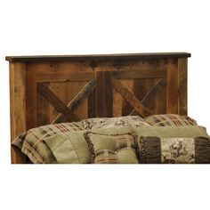 the headboard is made out of wood and has plaid pillows on top of it