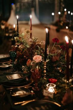 the table is set with candles, flowers and other things to decorate it for dinner