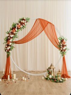 a wedding arch decorated with flowers and candles