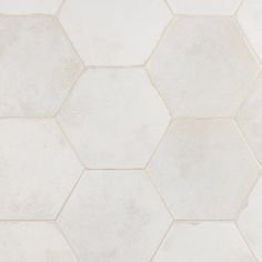 a white tile floor with hexagonal tiles on it