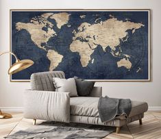 a living room with a couch, coffee table and large world map on the wall