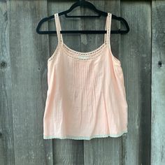 Beautiful Babydoll Top. Lace And Peachy Pink! Size Xs. Never Worn And In Perfect Condition! Super Unique And Casual Top. Let Me Know If You Have Any Questions Or Want More Photos! Happy Poshing! Feminine Cotton Camisole For Beach, Pink Tank Top For Summer Daywear, Pink Tank Top For Summer Sleepover, Pink Lace Trim Tank Top For Summer, Pink Cotton Tank Top For Daywear, Pink Cotton Camisole For The Beach, Cute Pink Camisole For The Beach, Cute Pink Camisole For Beach, Pink Sleeveless Cotton Camisole