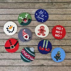 six christmas themed buttons on a wooden surface