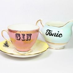 two tea cups and saucers sitting next to each other