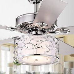 a ceiling fan with a white light inside of it in a living room or dining room