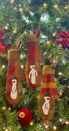 three stockings hanging from a christmas tree